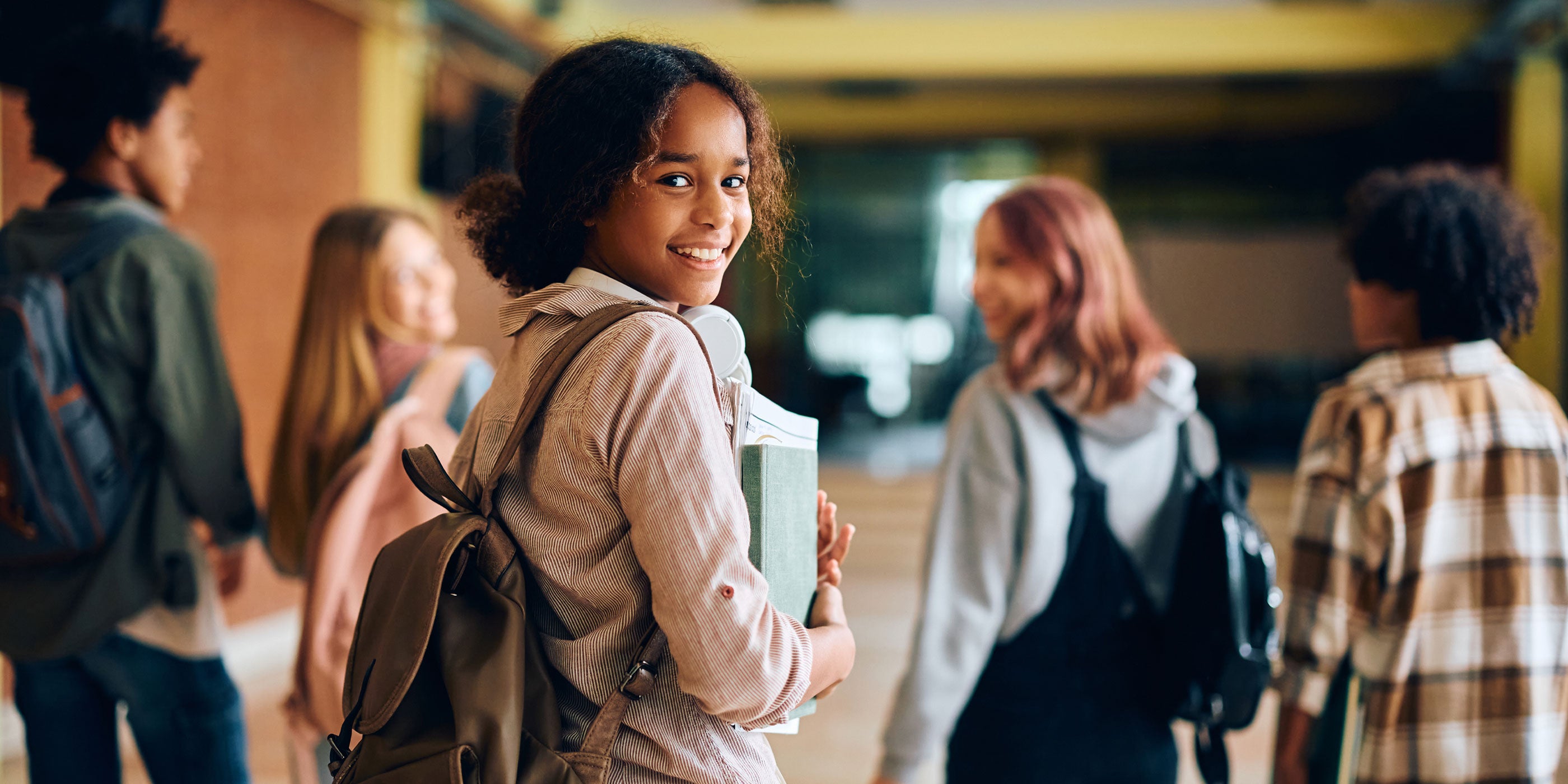 Smiling high school students walking in their school hallway