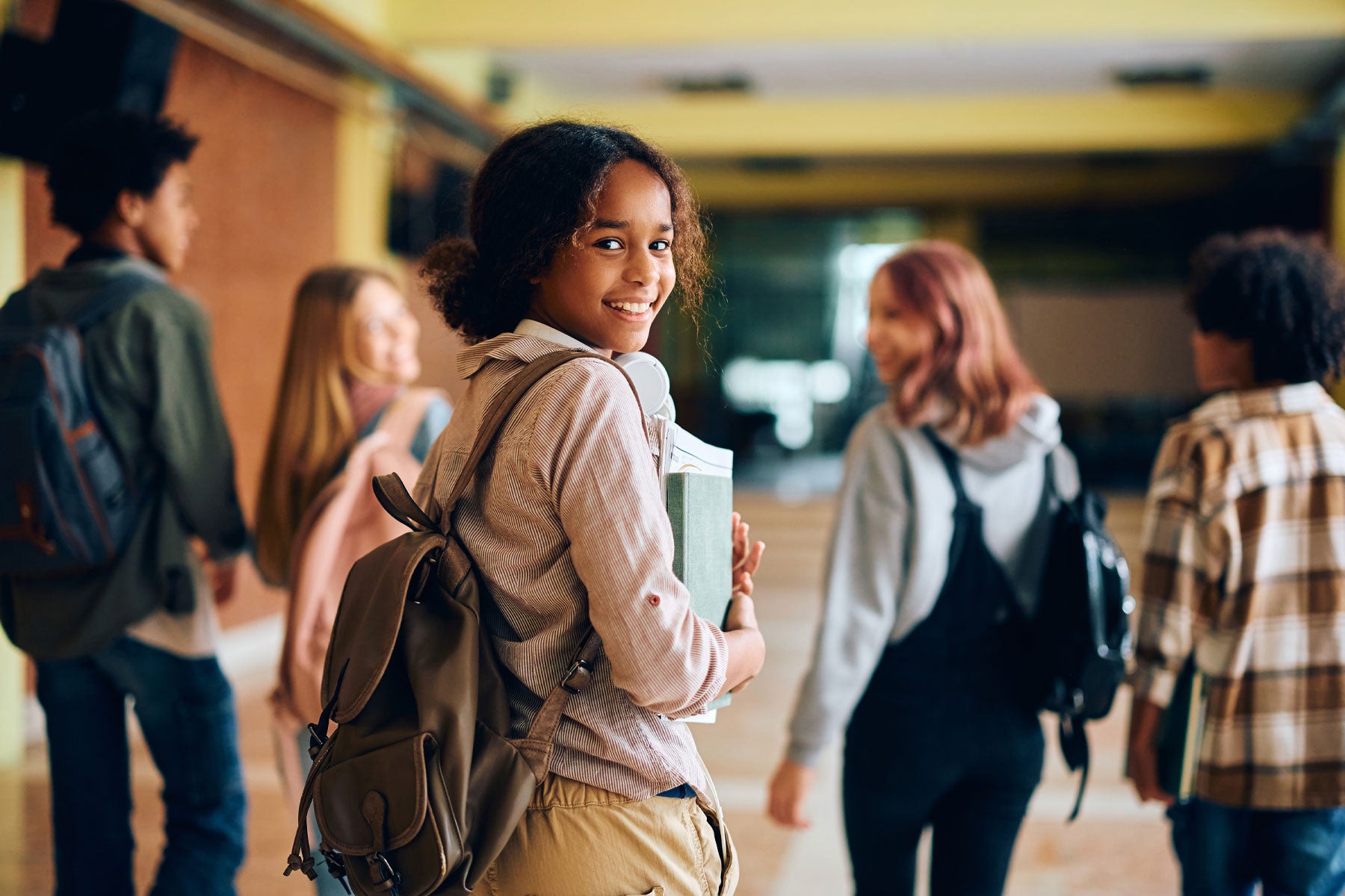 Smiling high school students walking in their school hallway
